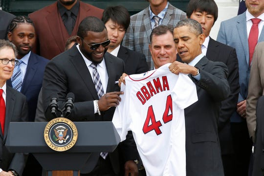 The former designated Red Sox hitter, David Ortiz (left), handed a shirt to former President Barack Obama (right) in 2013.