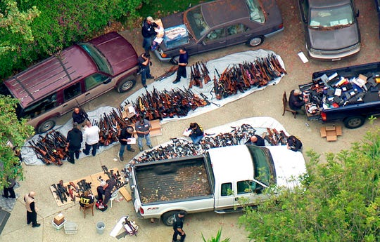 This photo from video provided by KCBS/KCAL-TV shows investigators from the U.S. Bureau of Alcohol, Tobacco, Firearms and Explosives and the police inspecting a large cache of weapons seized at a home in the affluent Holmby Hills area of Los Angeles Wednesday, May 8, 2019. Authorities seized more than a thousand guns from the home after getting an anonymous tip regarding illegal firearms sales in a posh area near the Playboy Mansion and served a search warrant around 4 a.m. Wednesday at the property on the border of the Bel Air and Holmby Hills neighborhoods.