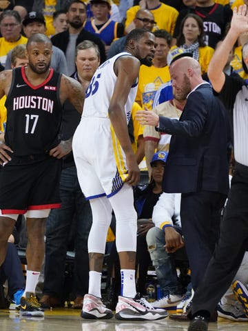 Golden State Warriors forward Kevin Durant leaves the court after an injury during the third quarter.