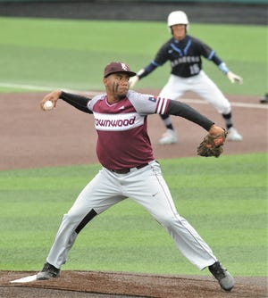 Brownwood pitcher Gavon Clemons throws a pitch in the first inning while Midland Greenwood runner Skyler Dominiguez leads off first base during Game 2 of their Region I-4A area playoff series Friday at ACU's Crutcher Scott Field.