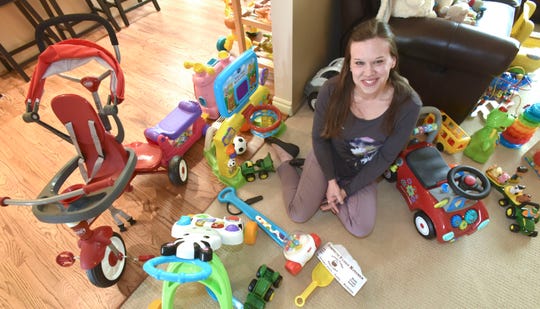 Samaritas-licensed foster parent Sarah Sporny poses among the toys of her son, Mikey, that she and her husband and Mikey's father, Robert, (neither pictured) will share with future foster children at their home in Farmington Hills.