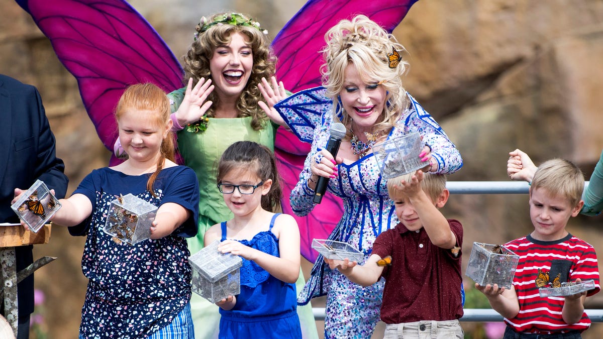 Dolly Parton helps children release butterflies during the grand opening of Dollywood's new Wildwood Grove expansion on Friday, May 10, 2019.
