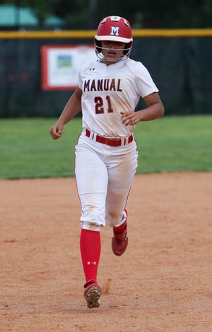 Manual's Jeanay Riley (21) heads towards third base after hitting a homerun against  Assumption at Manual High School.  Assumption won 13-12.
May 9, 2019