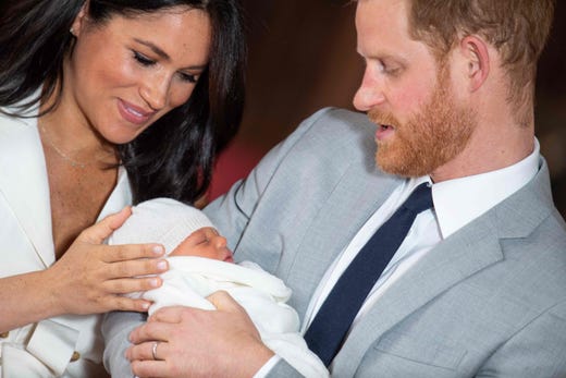 Prince Harry, Duke of Sussex, and his wife Meghan, Duchess of Sussex, pose for a photo with their newborn baby son, Archie Harrison Mountbatten-Windsor, in St. George's Hall at Windsor Castle in Windsor, west of London, on May 8, 2019.