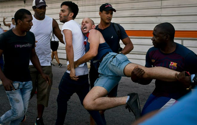Cuban police detain a gay rights activist taking part in an unauthorized march in Havana, Cuba, Saturday, May 11, 2019.