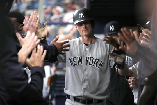 New York Yankees second baseman DJ LeMahieu (26) is commended for his feat as he marks a race in the first round against the Tampa Bay Rays at Tropicana Field.