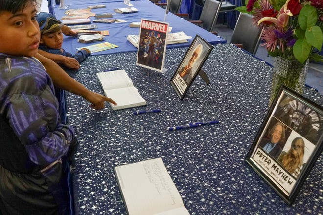Books are signed at the Palm Springs Public Library Comic Con in remembrance of Stan Lee and Peter Mayhew, Palm Springs, Calif., May 11, 2019.
