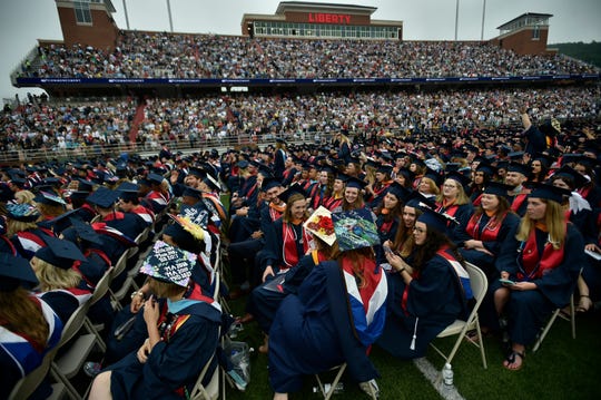 Graduates are chatting as students continue to attend the inauguration ceremony of Liberty University in Lynchburg on Saturday, May 11, 2019. More than 45,000 people attended the event where the Vice President Mike Pence delivered the opening speech.