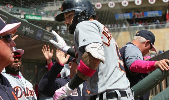 Nicholas Castellanos, of the Detroit Tigers, is greeted in the dugout after his two-run circuit off Minnesota Twins pitcher, Martin Perez, in the first round of a baseball game on Sunday, May 12, 2019 in Minneapolis. .
