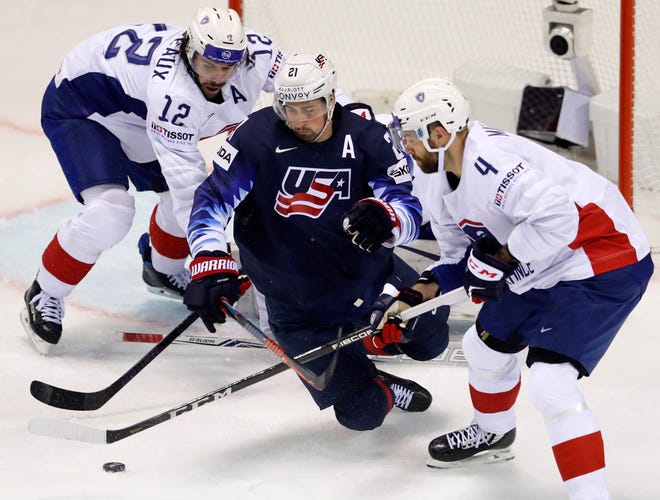 Antonin Manavian of France, right, battles Dylan Larkin of the U.S. during Sunday's game.