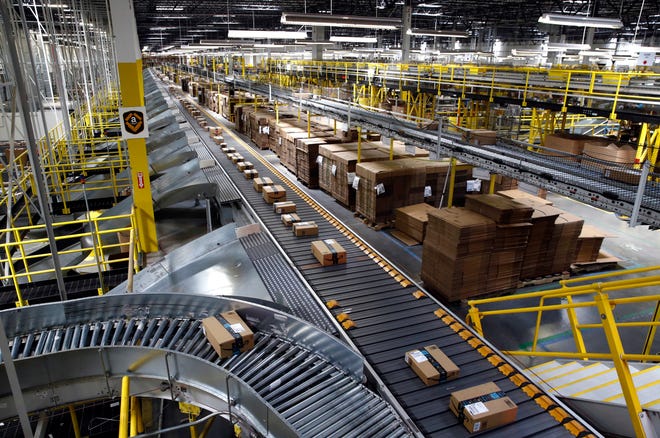 Packages ride on a conveyor system at an Amazon fulfillment center in Baltimore.