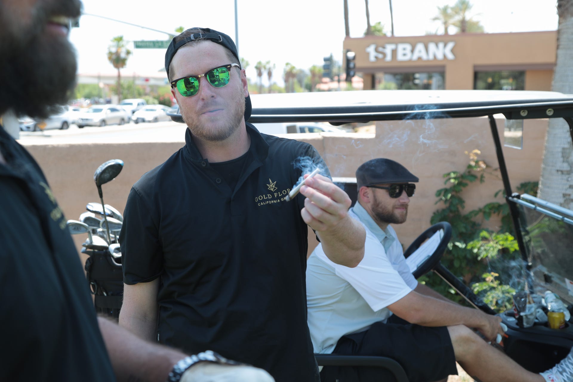 Perry Holcomb passes a joint between his group of golfers at the Coachella Valley Cannabis Alliance Network's charity golf tournament, Palm Desert, Calif., May 11, 2019.