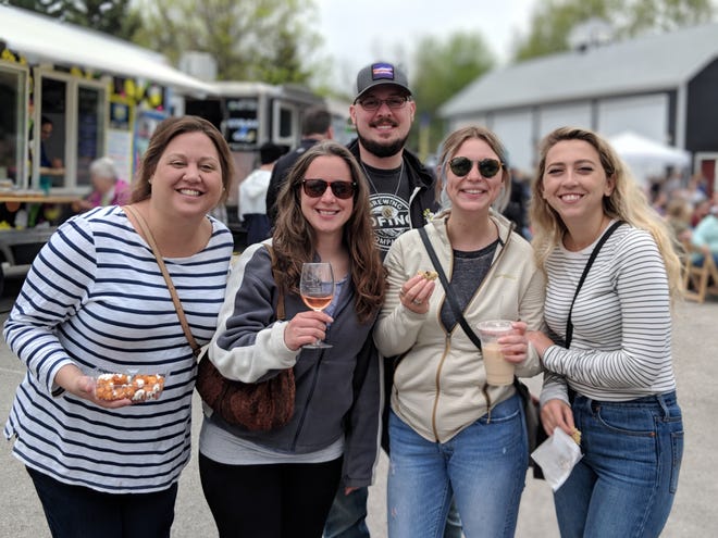 Gourmet Food Truck Festival attendees pose with some of their treats.
