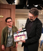 'The Big Bang Theory' co-creator Chuck Lorre, right, handles the slate marking the final taped scene of the 12-season CBS comedy as actor Johnny Galecki watches.