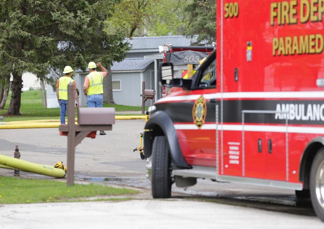 Alliant Energy workers look over the scene where a car hit a trailer Tuesday afternoon, causing a gas leak in the Gaslight Terrace Mobile Home park in North Fond du Lac. Residents within a half mile of the scene are being evacuated.