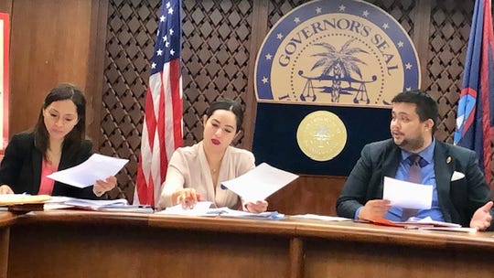 Guam Cannabis Control Board member William Parkinson, right, gestures as he talks about some of the questions from the public regarding the law on adult cannabis use, while Board Chairwoman Vanessa Williams, center, and Vice Chairwoman Dafne Shimizu, left, review documents during the board's second meeting on May 14, 2019.