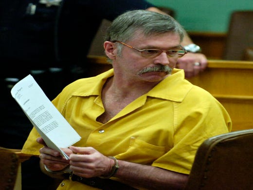 Rocky Joe Houston, accused along with his brother of killing a deputy and his ride-along friend, looks back at his family in court Friday during a hearing in Kingston. Rocky Houston and his brother Clifford Leon Houston are accused in the death of Roane County Sheriff's Department Deputy William Birl Jones and ride-along Gerald Michael Brown last May.