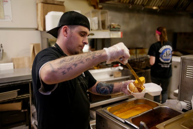 Matthew Sparger prepares a chili cheese dog at AJ's, Tuesday, May 14, 2019, in West Lafayette.  The new location will be located at 302 Vine Street.