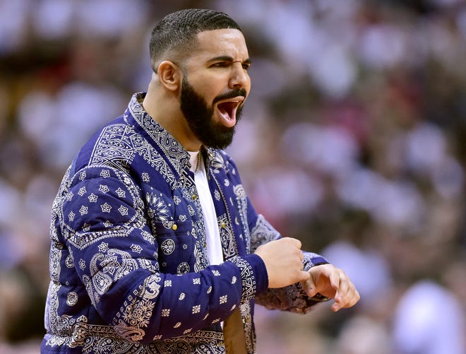 Rapper Drake, a huge fan of the Toronto Raptors, reacts from his courtside seat during the second half of the team's Game 1 second-round playoff series against the Philadelphia 76ers on Saturday, April 27. Drake has a close relationship with the franchise.