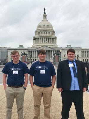 Garrett Gray, Zach Reddick and Wyatt Wiggins wait in front of the U.S. Capitol  before presenting their app to members of Congress.