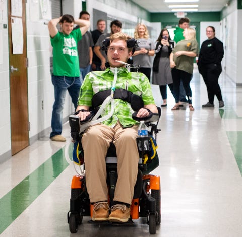 Jefferey Cox races down the hallway with his...