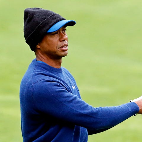 Tiger Woods plays from the fairway on the ninth...