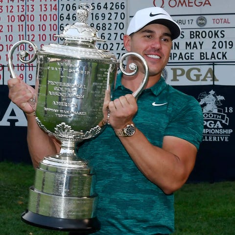 Brooks Koepka poses with the Wanamaker Trophy...