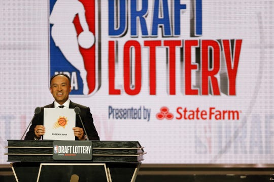 NBA Deputy Commissioner Mark Tatum announces that the Phoenix Suns had won the sixth pick during the NBA basketball draft lottery Tuesday, May 14, 2019, in Chicago.