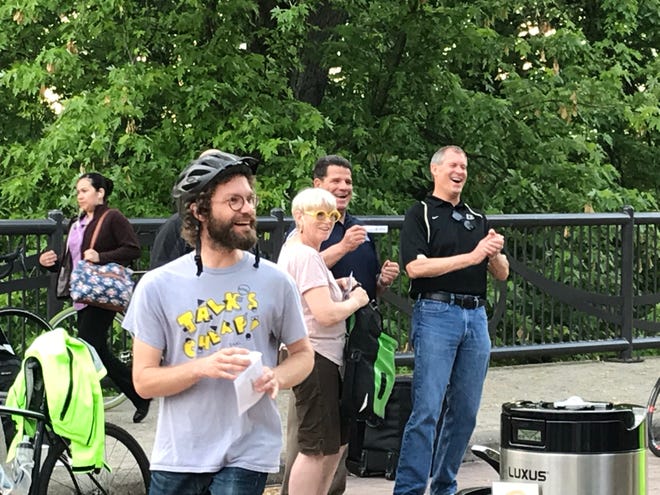 Zachary Baiel, left,  took part in Bike to Work Day events Friday, May 17, 2019, on the John T. Myers Pedestrian Bridge moments before telling West Lafayette Mayor John Dennis, right, that he intends to challenge him in the November municipal election. Baiel plans to run as an independent against Dennis, a Republican who had been uncontested in his bid for a fourth term in West Lafayette.