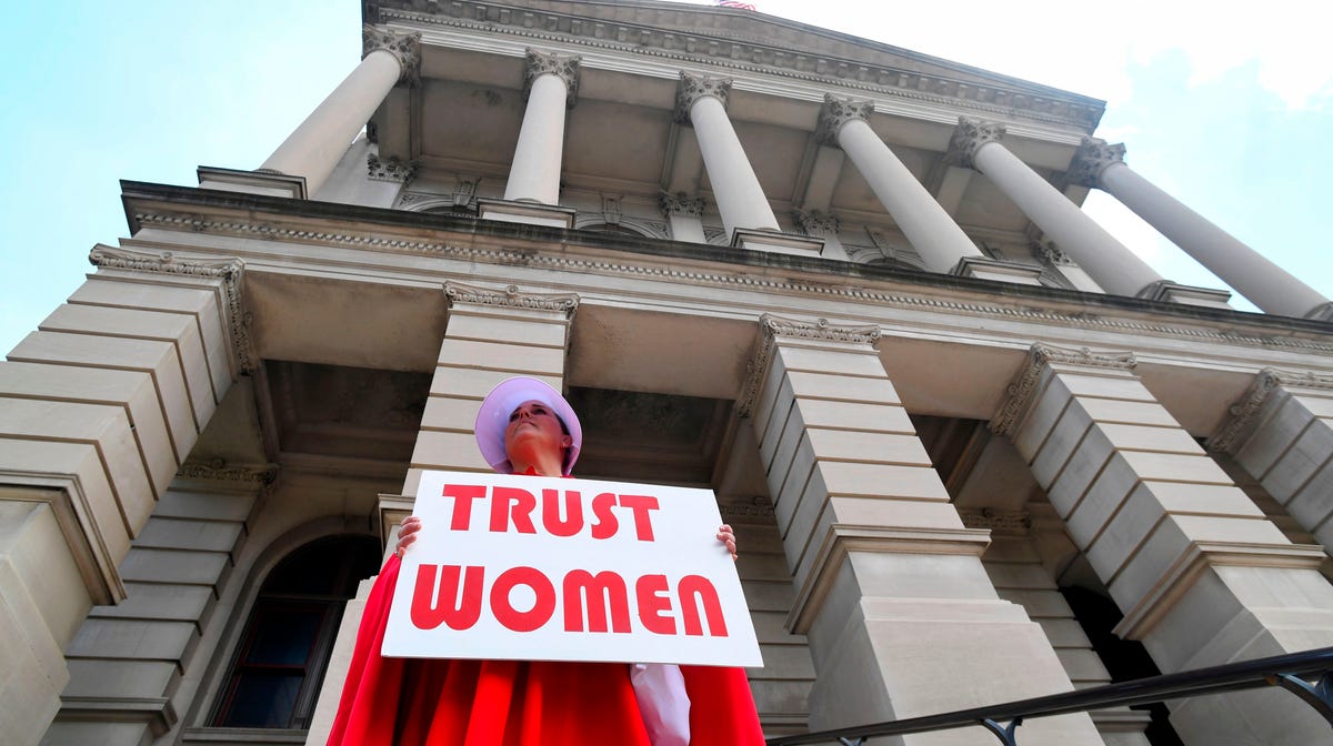 Activist Tamara Stevens with the Handmaids Coalition of Georgia stands outside the Georgia Capitol on May 16, 2019 in Atlanta.