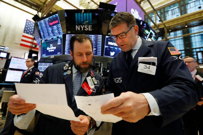 Specialists Michael Pistillo, left, and David Haubner confer on the floor of the New York Stock Exchange, Tuesday, May 14, 2019.