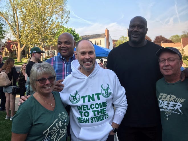 TNT broadcaster Ernie Johnson (white sweatshirt) visits his childhood home in Milwaukee on May 16, joined by (from left) current homeowner Kim Nelson, Charles Barkley, Shaquille O'Neal and current homeowner Pat Nelson.