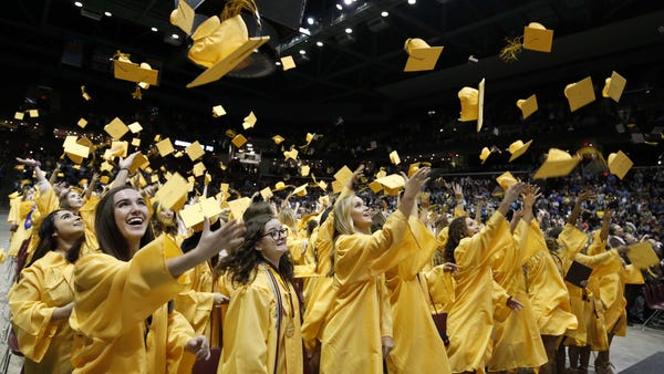 Graduates toss their caps at Kickapoo High...