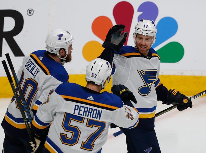 St. Louis's Ryan O'Reilly (90) and David Perron (57), celebrate with Jaden Schwartz, who scored a goal against the San Jose Sharks on Sunday.