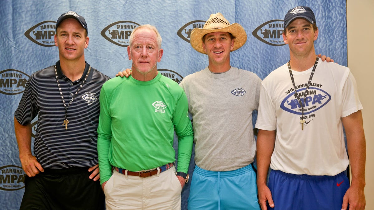 Peyton Manning, Archie Manning, Cooper Manning and Eli Manning pose for a group photo at a press conference at the Manning Passing Academy.