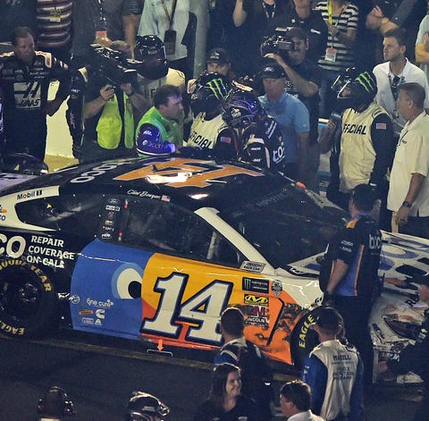 A NASCAR official tries to get between drivers...