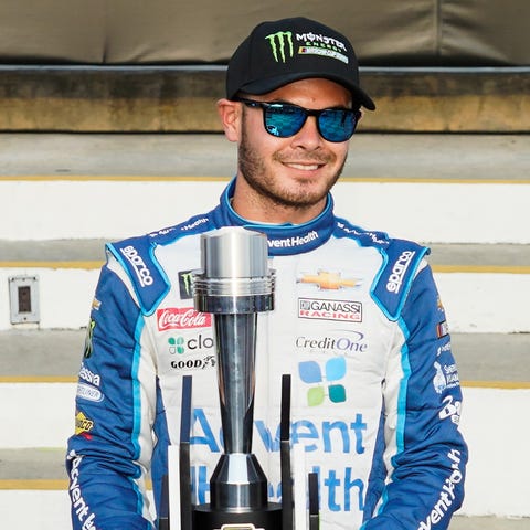 Kyle Larson holds the trophy after winning the...