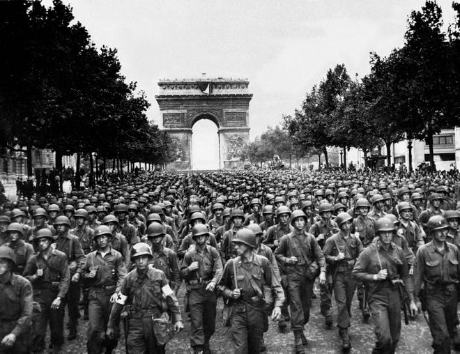 Eisenhower did not consider Paris a vital military objective and chose not to commit troops to the capital after D-Day. But after the French Resistance staged an uprising on Aug. 9, 1944, he relented, and American and Free French troops made a peaceful entrance on Aug. 25. Here, four days later, soldiers of Pennsylvania's 28th Infantry Division march along the Champs-Elysees, with the Arc de Triomphe in the background.