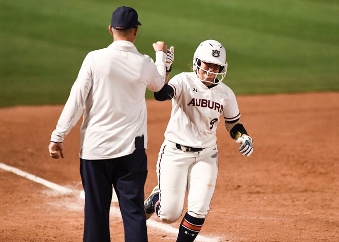 Auburn's Tannon Snow (9) high-fives coach Mickey Dean as she rounds third base against Colorado State on Friday, May 17, 2019, in Tucson, AZ.