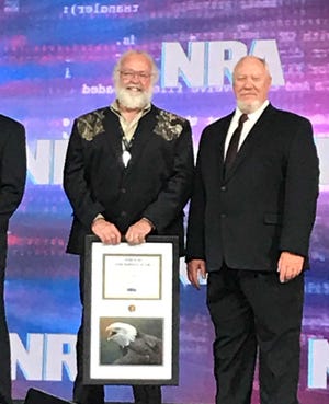 Don Pagath (left) received his Southern Ohio volunteer of the year award during last month's National NRA convention in Indianapolis. Eastern Region Director Bryan Hoover (right) presented the award.