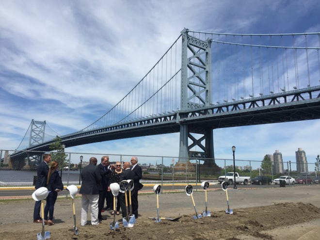 Camden officials gather with representatives from Hilton, Ensemble Real Estate Investments, Intech Construction and others before breaking ground on a new waterfront hotel, the first in Camden in more than 50 years.
