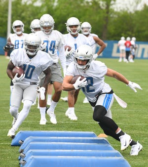 Lions wide receiver Danny Amendola works his way through the obstacles during drills.