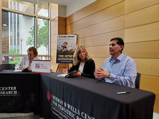 Tony and Kelly Trent, Tyler Trent's parents, are joined by cancer researcher Dr. Karen Pollok of Wells Center for Pediatric Research and Riley Precision Genomics during a book signing for Tyler's book, 