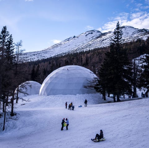 Tourists sledge in front of Tatra Ice Temples at...