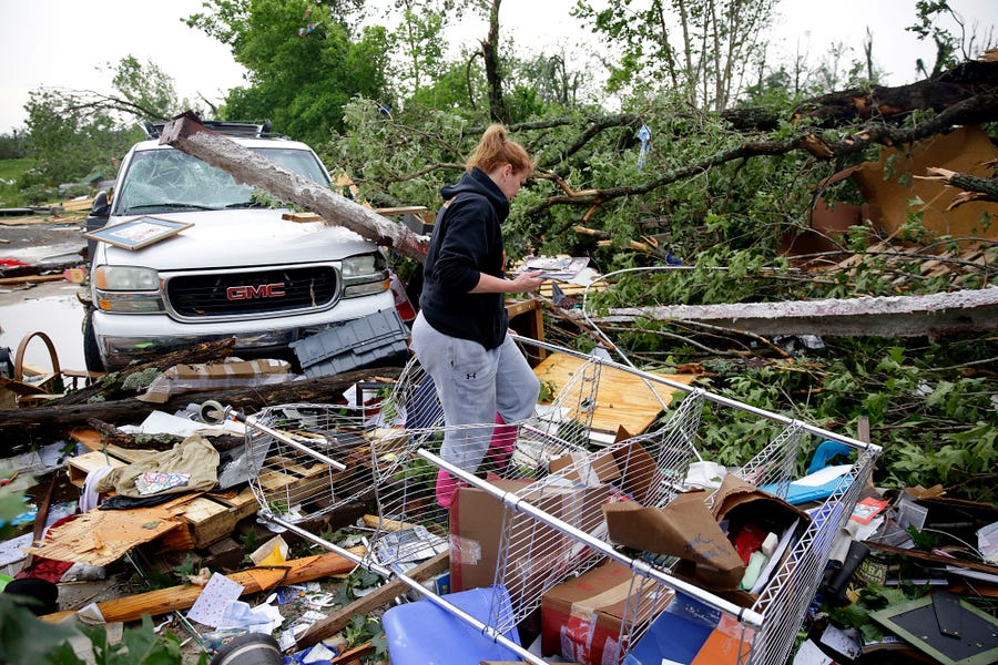 Michelle Underwood searches through the wreckage of a feed store on May 21, 2019, in Peggs, Okla. She had most of her belongs stored in the building.  An apparent tornado hit the area Monday night.