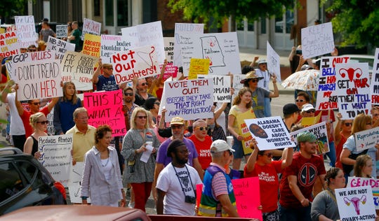 Protesters march to the Alabama Capitol to protest a bill to ban abortion that passed last week , Sunday, May 19, 2019, in Montgomery, Ala.
