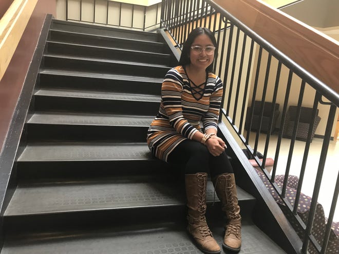 Ahtziry Vasquez, 17, sits on steps at Truckee Meadows Community College. She is one of 63 students graduating with a two-year degree from TMCC before she graduates high school. TMCC High is a dual enrollment program where students take college classes.