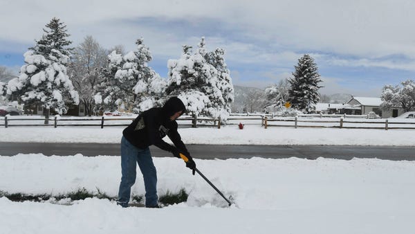 Steve Fairclough shovels through deep, heavy snow...