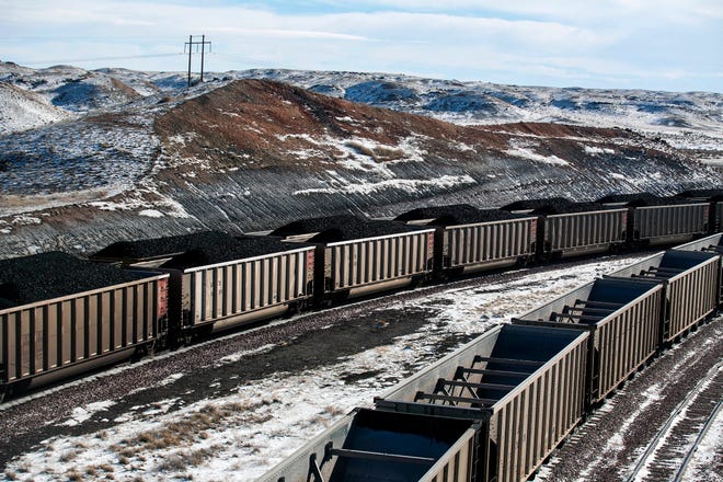 FILE - In this Jan. 9, 2014, file photo, rail cars are filled with coal and sprayed with a topper agent to suppress dust at Cloud Peak Energy's Antelope Mine north of Douglas, Wyo. Four states with climate change worries are asking a judge to stop the Trump administration from selling coal from public lands. Attorneys general from California, New Mexico, New York and Washington are due in a U.S. courtroom in Montana on Thursday, Dec. 13, 2018, to argue the sales put the climate at risk and shortchange taxpayers. Federal officials say the Trump administration's decision to lift a moratorium on coal sales from public lands could hasten the release of more than 5 billion tons of greenhouse gasses. (Ryan Dorgan/The Casper Star-Tribune via AP, File)