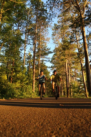 Cyclists ride on the Heart of Vilas trail system through Vilas County.